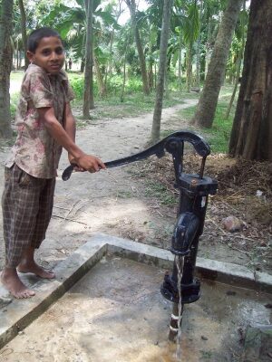 Vietnamese boy using a tube well.