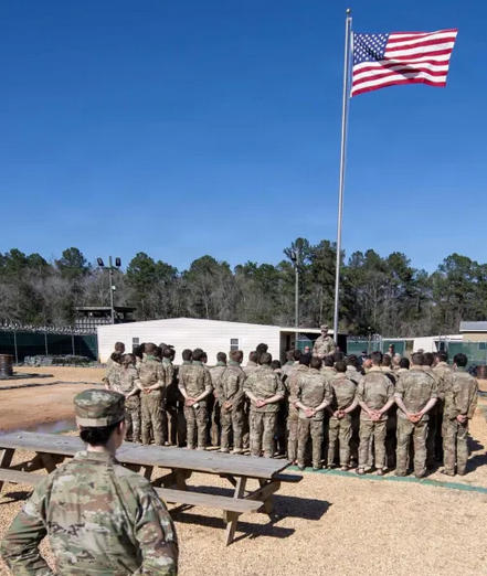 Students at the Army’s Survival, Evasion, Resistance, and Escape course at Fort Rucker complete their culminating exercise, and gather to salute the American flag as they begin the repatriation process during the recent large-scale reintegration exercise, March 14-18, 2026. Courtesy of the U.S. Army