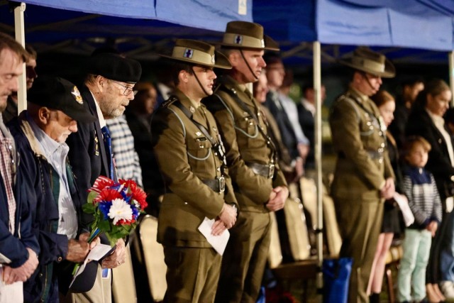 Retired Lt. Col. Fred Dunaway, former commander of the 135th Assault Helicopter Company, Australian Capt. Luke Gadd, and Australian Capt. Peter Oliver pay their respects during the 2026 ANZAC Day Dawn Service at Fort Rucker on April 25, 2026. (Leslie Herlick)