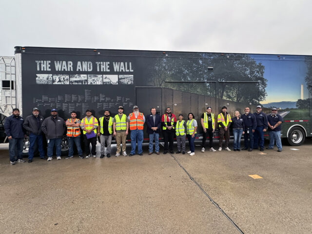 College officials and Instructors and students with the Transportation Training Services program at Del Mar College lined up for a photo with The Wall That Heals.