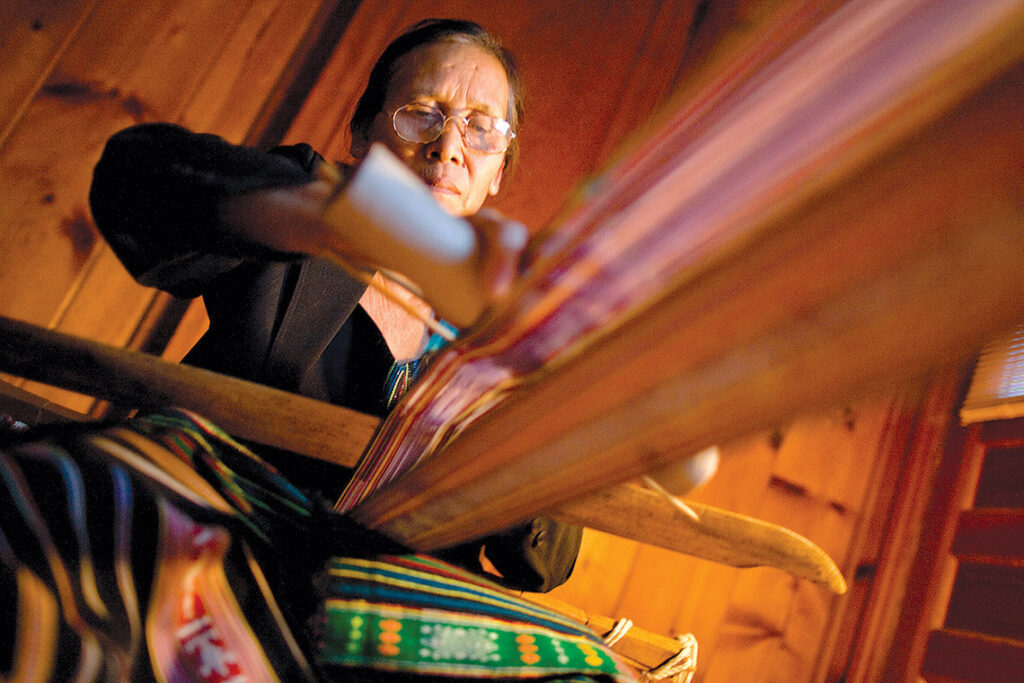 Before she died in 2021, H Ju Nie’s talent for backstrap weaving helped keep the Montagnard tradition alive. On a loom built by her husband, Nie designed intricate blankets, clothing, baby carriers, and bags — each a work of art. photograph by Jerry Wolford
