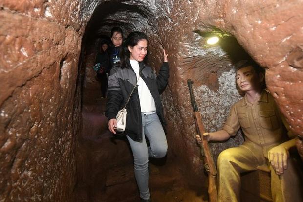 A guide walks past a concrete model of a militia member inside the Vinh Moc tunnel network in Vietnam's central coastal province of Quang TriHOANG DINH NAM, AFP