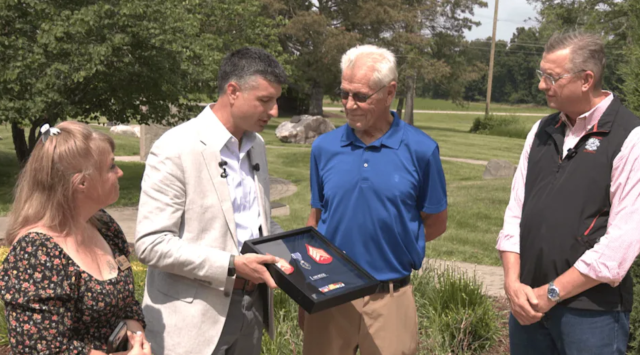 Rep. Tom Barrett, R-Charlotte, presents Robert Haywood with new copies of his medals alongside Secretary of Veterans Affairs Doug Collins and Eaton County Commissioner Nicole Christensen. (David Sackrider/WLNS)