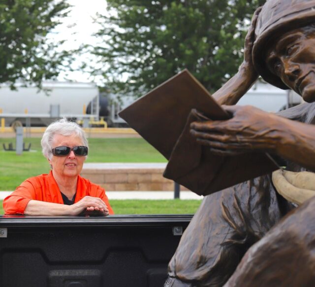 Bronze sculptor Pamela Harr gets a look at her latest work, “Letter from Home”, before it was lifted and placed at Veterans Memorial Park on Aug. 15.
Darren Frey/Glendive Ranger Review